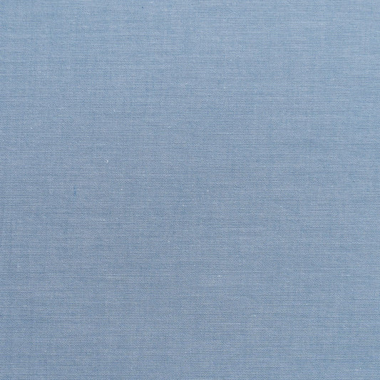 A swatch of Chambray Basics Blue fabric from Tilda Fabrics, displaying a woven texture in blue color.
Photo by Tildafabrics.com [image_link]