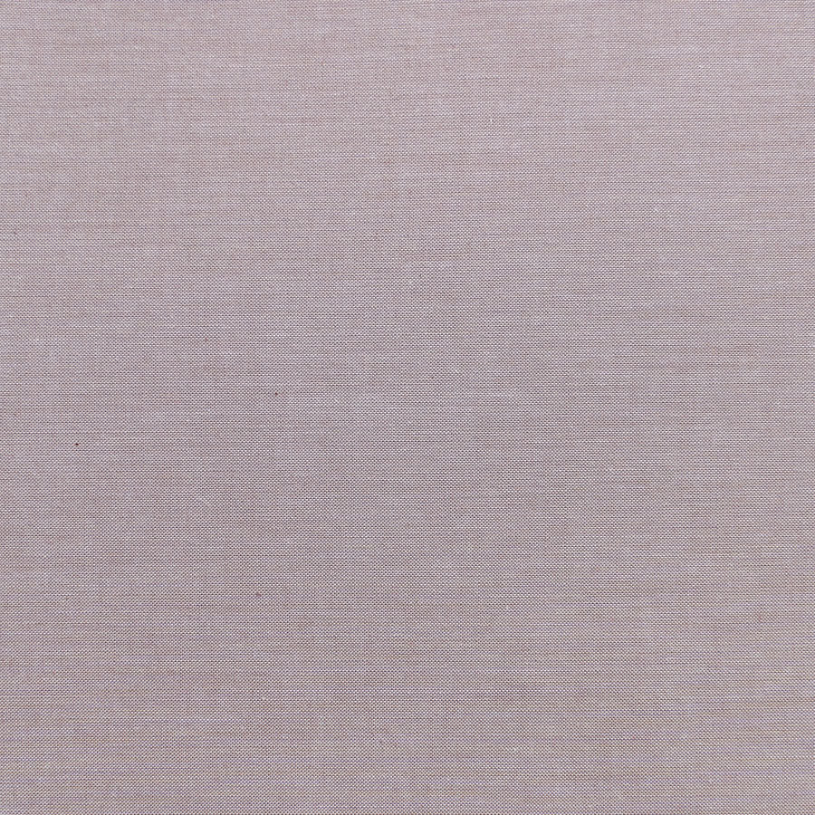 A close-up view of a remnant piece of Chambray Basics Sand fabric with a solid beige color and a textured weave.
Photo by Tildafabrics.com [image_link]