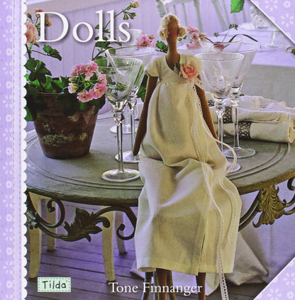 Doll in a yellow dress sitting at a table with flowers and glasses, Tilda brand visible
Photo by Tildafabrics.com [additional_image_link]