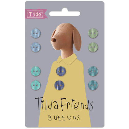 Tilda Friends buttons packaging with a dog illustration and buttons on a gray background.
Photo by Tildafabrics.com [additional_image_link]