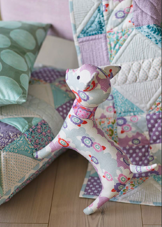 A sewing kit for creating a playful kitten doll, featuring various patterned fabric pieces and a printed instruction sheet.
Photo by Tildafabrics.com [image_link]