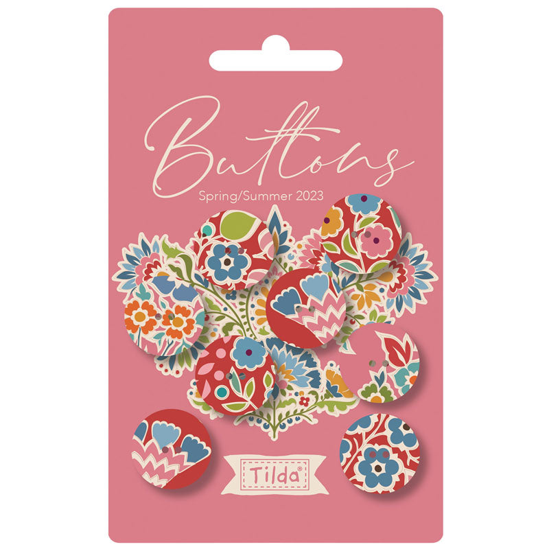 Pack of colorful buttons with floral designs on a pink card featuring the brand 'Tilda'.
Photo by Tildafabrics.com [image_link]