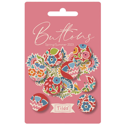 Pack of colorful buttons with floral designs on a pink card featuring the brand 'Tilda'.
Photo by Tildafabrics.com [image_link]