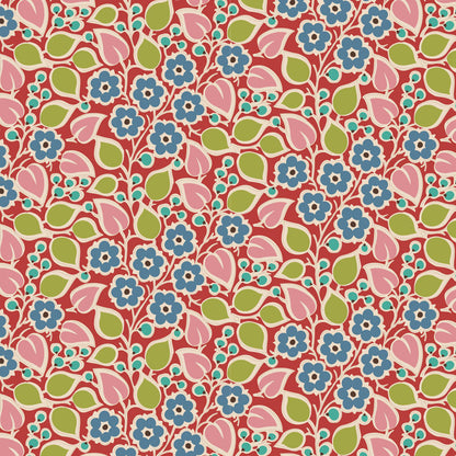 A close-up of a repeating floral patterned fabric or wallpaper sample with a ruler scale on the left edge. The pattern features pink flowers with blue centers and green leaves on a coral-red background.
Photo by Tildafabrics.com [additional_image_link]