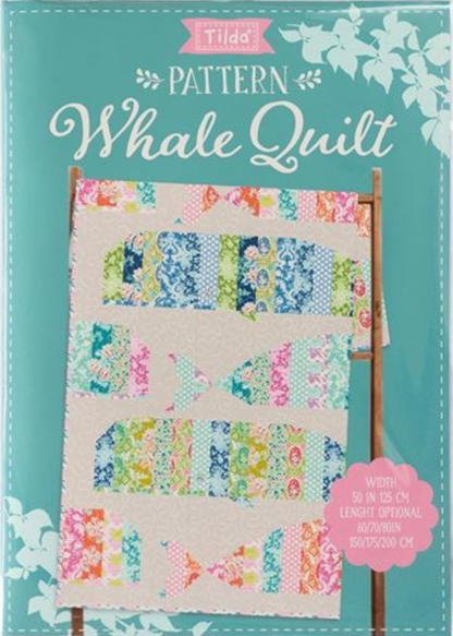 Tilda Tilda 'Pattern Whale Quilt' book cover, featuring a colorful patchwork whale quilt design on a light beige background, set against a teal cover with white floral accents.
Photo by Tildafabrics.com [additional_image_link]