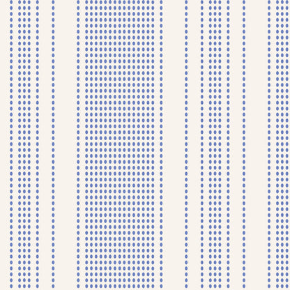 A close-up of a fabric pattern featuring vertical stripes with dense rows of small blue dots on a warm off-white background.
Photo by Tildafabrics.com [image_link]