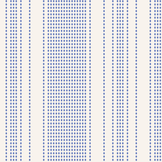 A close-up of a fabric pattern featuring vertical stripes with dense rows of small blue dots on a warm off-white background.
Photo by Tildafabrics.com [image_link]