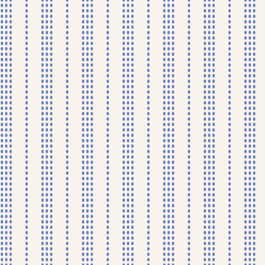 A repeating vertical stripe pattern featuring rows of small blue dots on a warm off-white background.
Photo by Tildafabrics.com [image_link]
