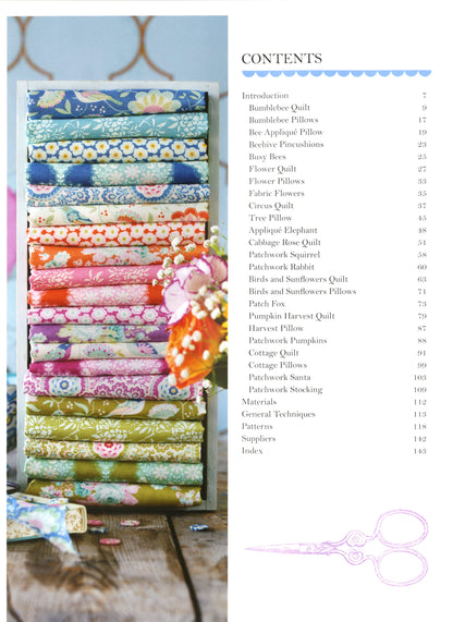 Stack of colorful fabric rolls with a table and chair in the background, next to a table of fabric pieces.
Photo by Tildafabrics.com [additional_image_link]