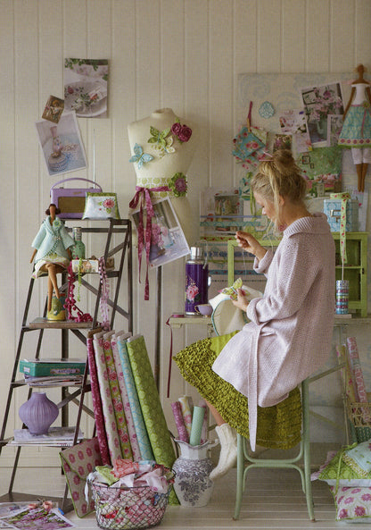Woman in a craft room surrounded by materials and decorations
Photo by Tildafabrics.com [additional_image_link]