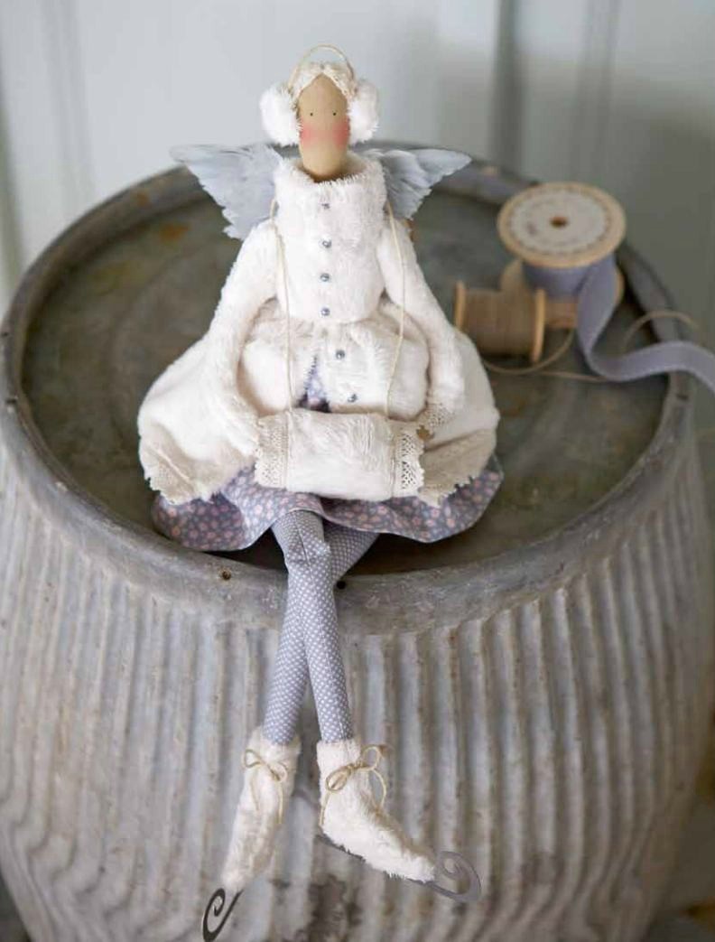 Ice skating angel doll dressed in a white winter coat, earmuffs, skates and a muff.
Photo by Tildafabrics.com [additional_image_link] 