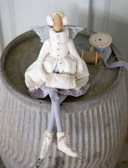 Ice skating angel doll dressed in a white winter coat, earmuffs, skates and a muff.
Photo by Tildafabrics.com [additional_image_link] 