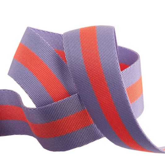 A spool of Tula Pink striped Nylon Webbing in lavender and neon peach colors, used for sewing and crafting.
Photo by RenaissanceRibbons.com [image_link]