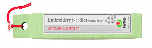 A light green spool of Hiroshima needles with a red hanging cord and a white label that reads 'Embroidery Needles Assorted Sharp Tip' and 'HIROSHIMA NEEDLES'.
Photo by Tulip [image_link]