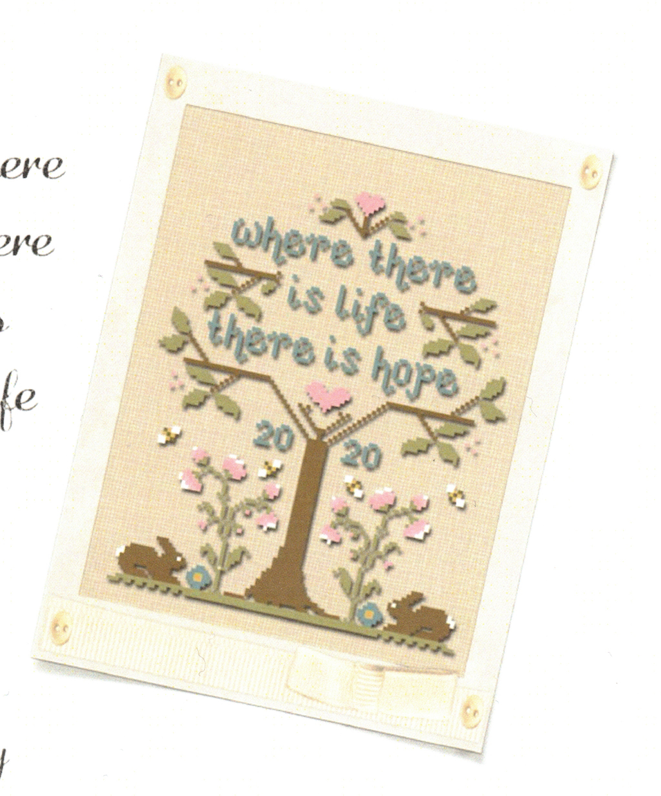 A cross stitch kit depicting a tree with heart shapes and the phrase 'WHERE THERE IS LIFE THERE IS HOPE' on a light background.
Photo by Country Cottage Needleworks [image_link]