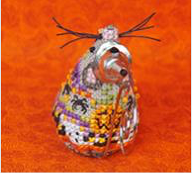 A small handcrafted beaded decorative mouse with a silver-toned base, covered in multicolored beads including orange, yellow, green, purple, and black, with dark twig-like antennae on top, set against a bright orange textured background.
Photo by JustNan.com [additional_image_link]