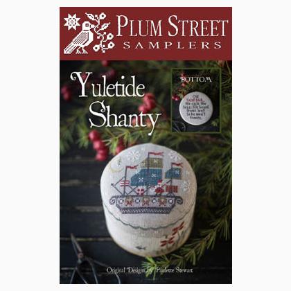 Front cover of the Plum Street Samplers 'Yuletide Shanty' sewing pattern, featuring a festive design with a white embroidered box, evergreen branches, red berries, and a dark wood background.
Photo by PlumStreetSamplers.com [additional_image_link]