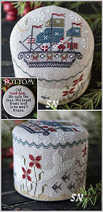 A collage showing two views of a round cross-stitch drum. The top view shows the front with a patriotic American flag and lighthouse design, and the bottom view shows the back with floral embroidery.
Photo by PlumStreetSamplers.com [additional_image_link]